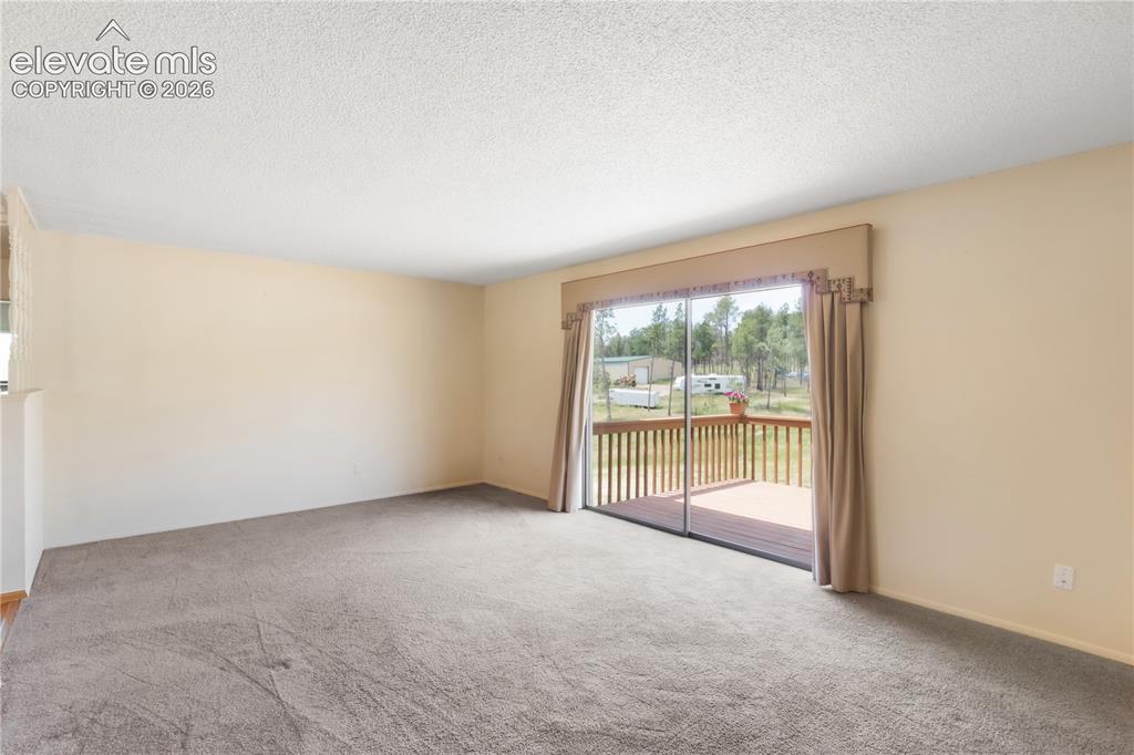 Image 21 of 47: Living area looking toward the entry, dining area to the left