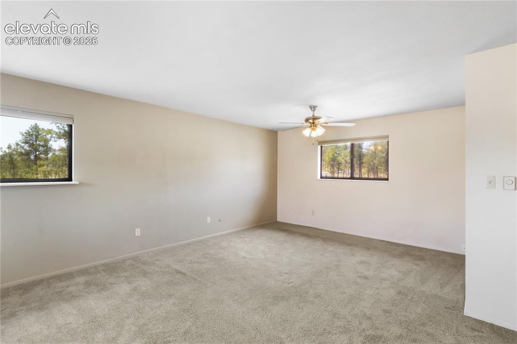 Image 22 of 47: Living room with doors to deck