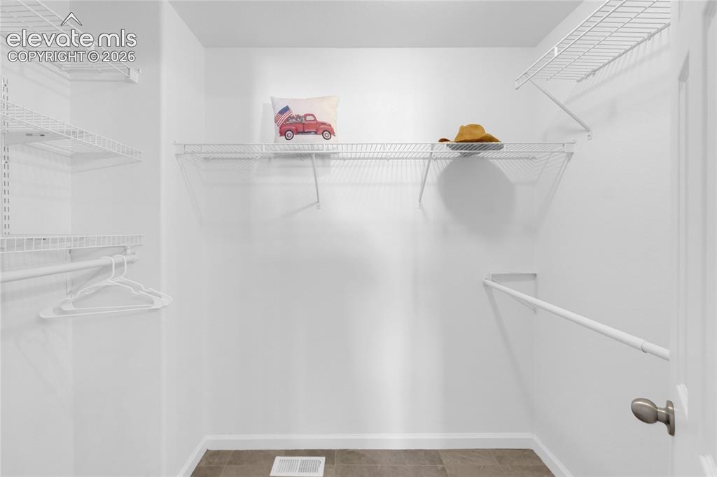 Image 22 of 40: Primary walk-in closet