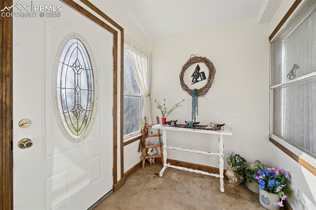 Image 13 of 45: Interior entry view leading into open living space 