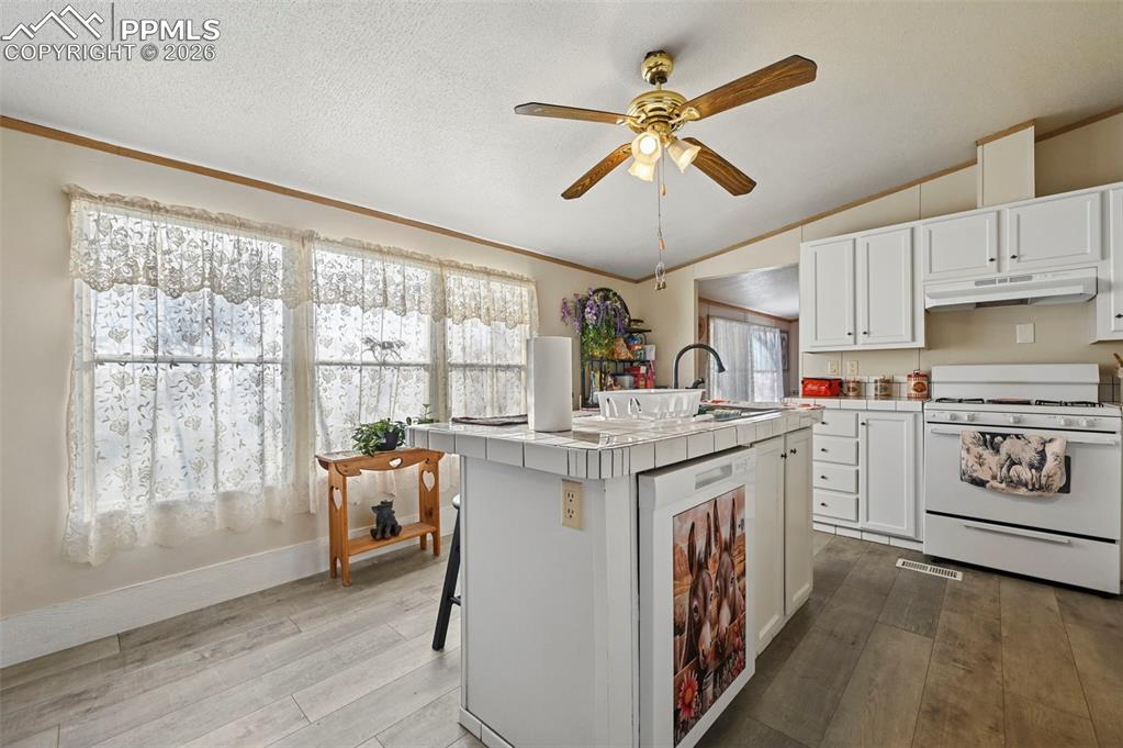 Image 21 of 45: Island workspace ideal for cooking, prep, and gathering 