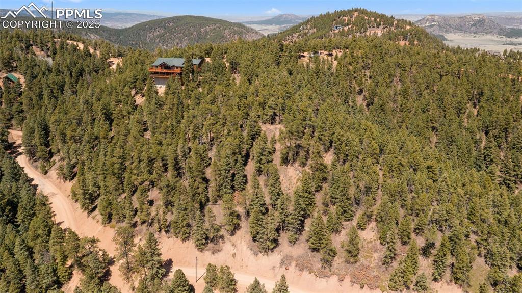Image 14 of 15: Mountain view with a heavily wooded area