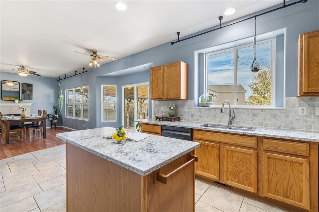Image 11 of 30: AWESOME WALL OF WINDOWS IN KITCHEN WITH SLIDER TO BACKYARD AND WINDOW OVER 