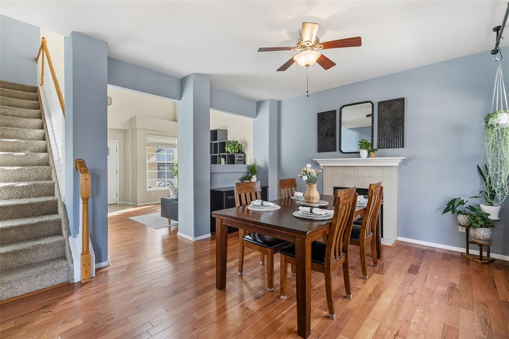 Image 13 of 30: VIEW OF DINING ROOM WITH FIREPLACE AND STIARCASE TO UPPER LEVEL