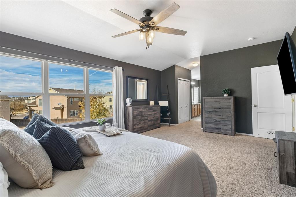 Image 15 of 30: PRIMARY BEDROOM WITH CEILING FAN ON UPPER LEVEL WITH VIEW INTO THE PRIMARY 