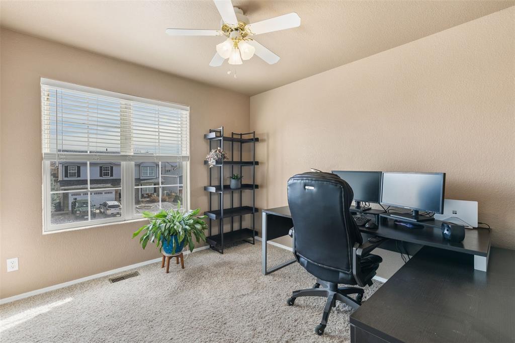 Image 21 of 30: 4TH BEDROOM WITH CEILING FAN ON UPPER LEVEL (CURRENTLY USED AS AN OFFICE)