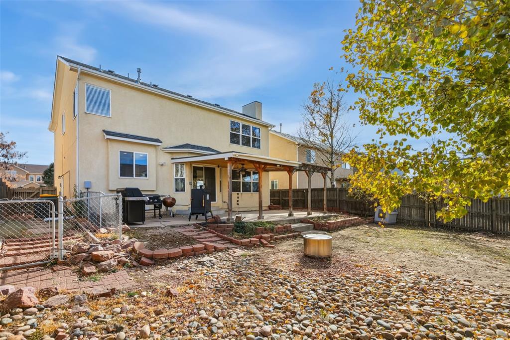 Image 28 of 30: BACK OF HOME WITH FENCED BACKYARD, DOG RUN AND COVERED PATIO & PERGOLA
