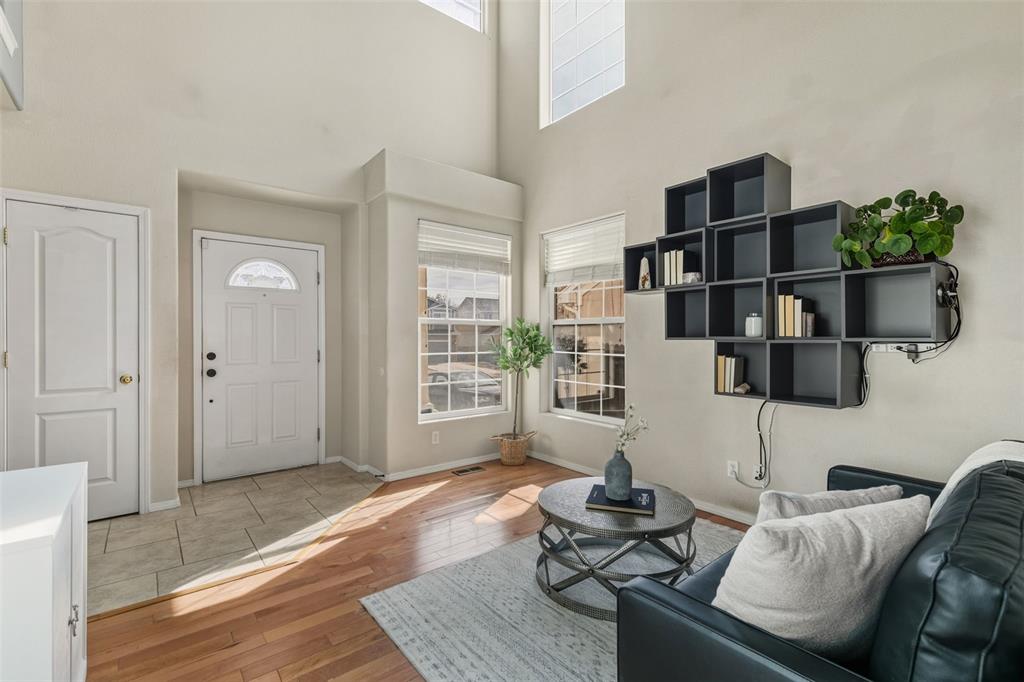 Image 4 of 30: LIVING ROOM WITH VIEW OF FRONT DOOR AND THE MANY WINDOWS THAT MAKE THIS ROO