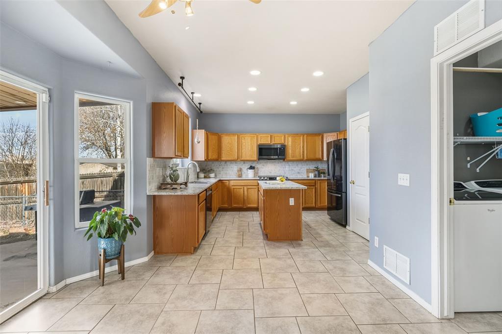 Image 7 of 30: THIS TILED SPACE COULD BE USED FOR A DINING ROOM AREA 