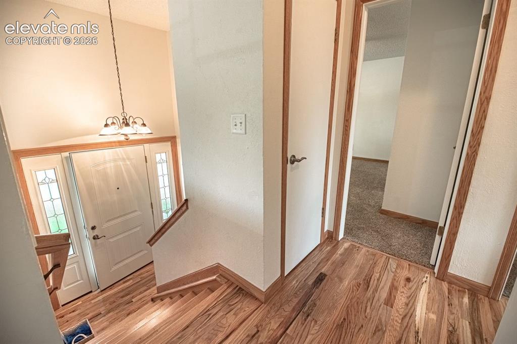 Image 14 of 34: Hardwood flooring extending from the landing