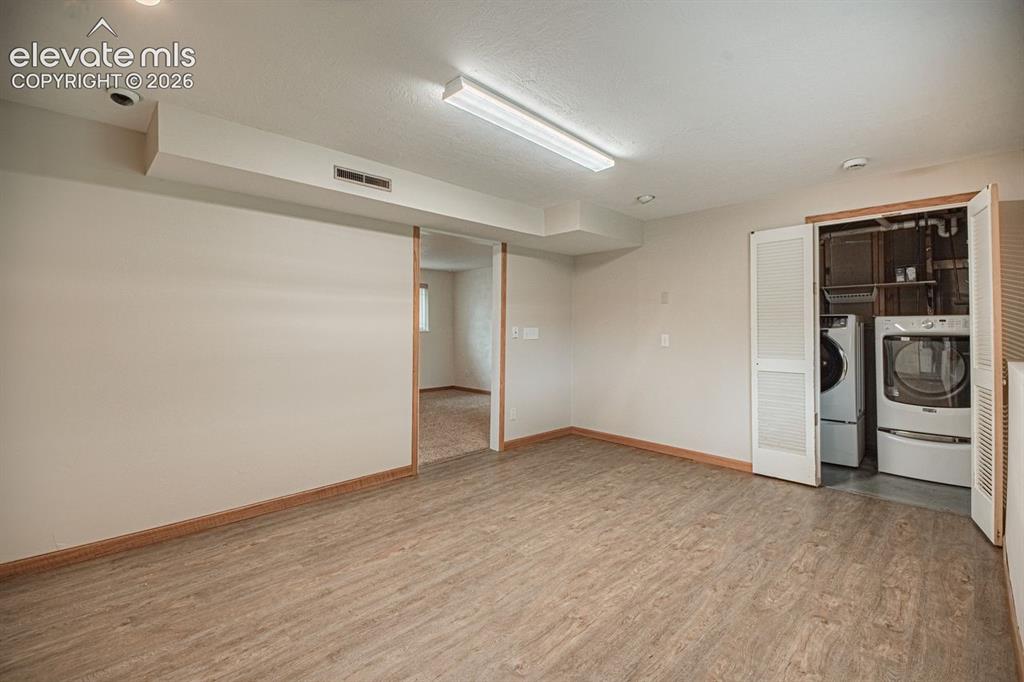 Image 26 of 34: Large storage room which includes washer/dryer