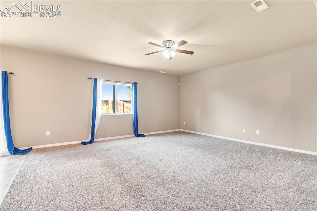 Image 16 of 43: Carpeted spare room with baseboards and a ceiling fan