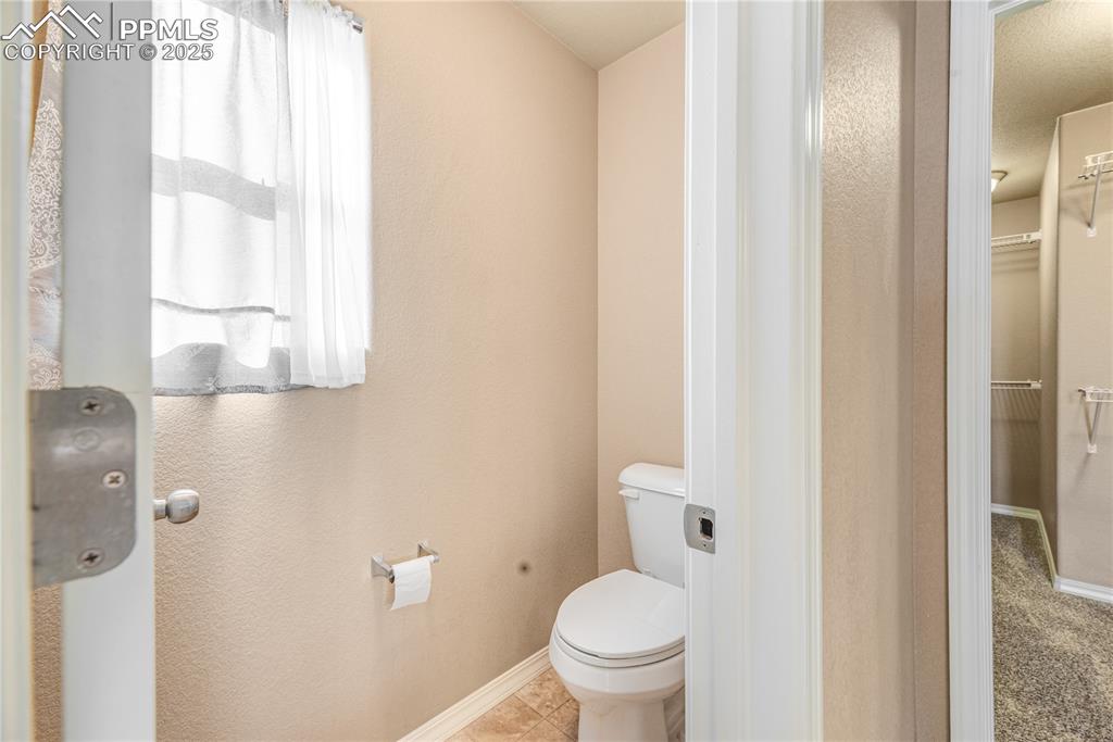 Image 24 of 43: Bathroom with toilet and a walk in closet