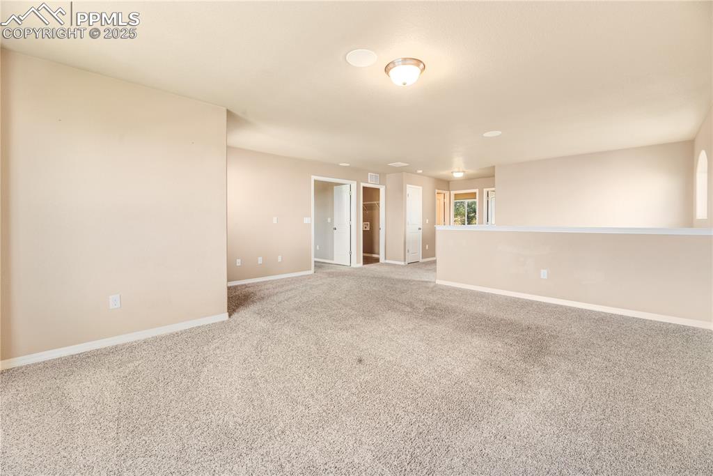 Image 28 of 43: Carpeted empty room with baseboards