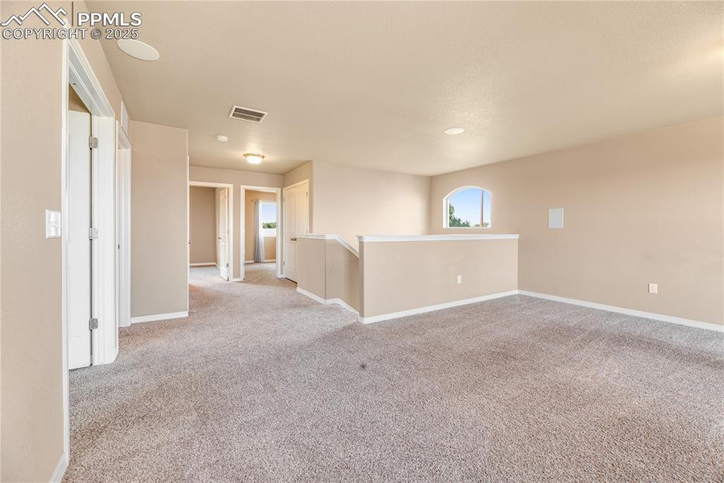 Image 29 of 43: Unfurnished room with light colored carpet and baseboards