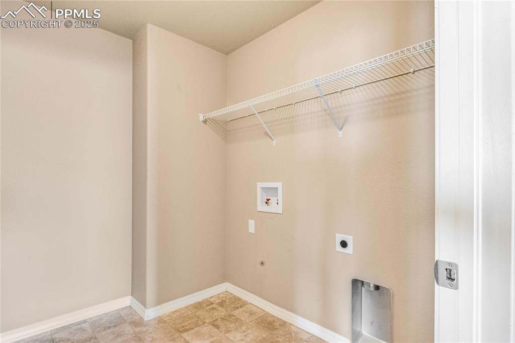 Image 30 of 43: Washroom featuring electric dryer hookup and washer hookup