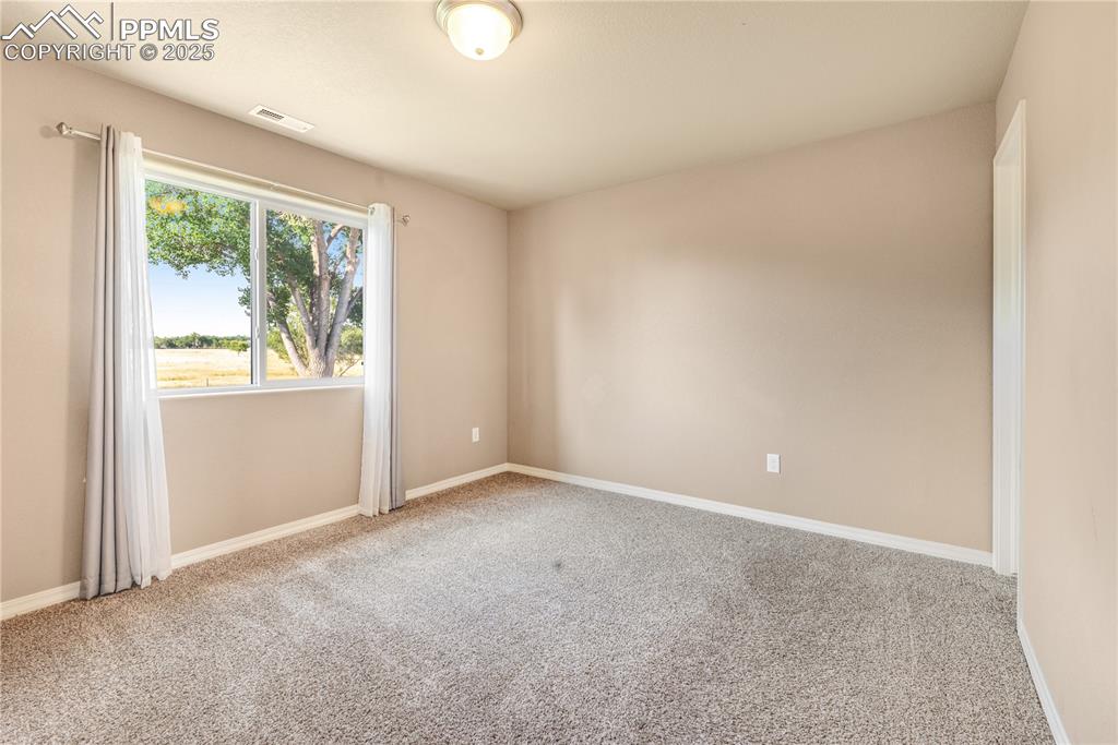 Image 35 of 43: Carpeted empty room with baseboards