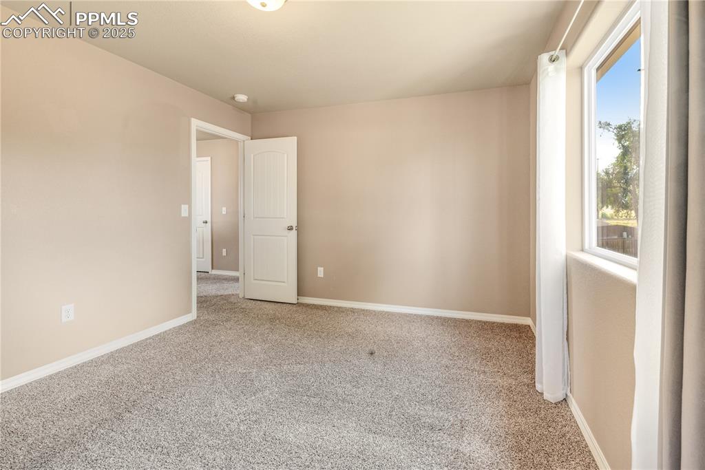 Image 36 of 43: Unfurnished room featuring light carpet and baseboards