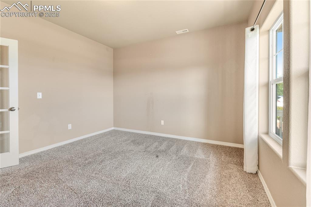 Image 38 of 43: Empty room featuring carpet floors and baseboards