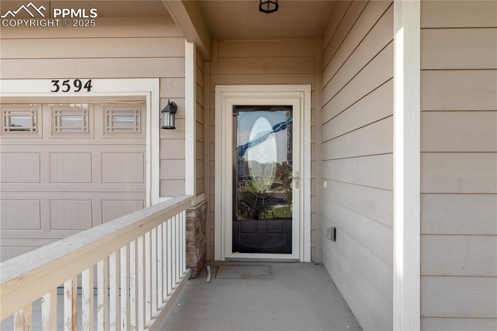 Image 4 of 43: Doorway to property with a garage