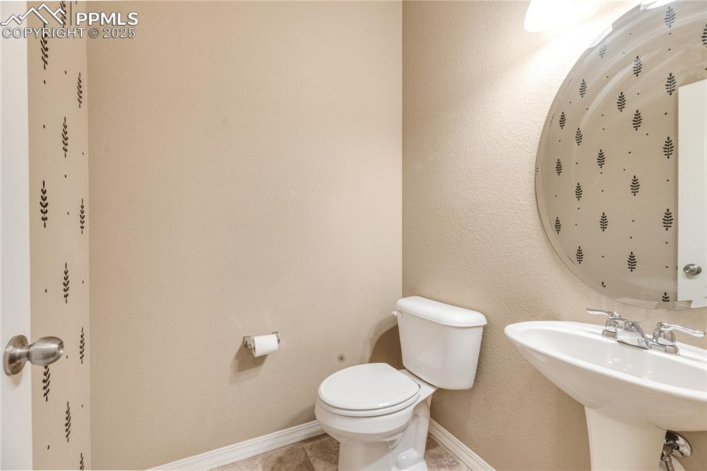 Image 40 of 43: Bathroom with a textured wall and toilet