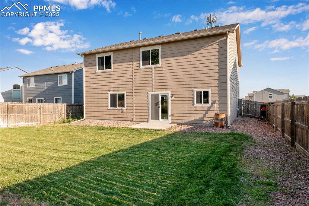 Image 41 of 43: Rear view of property with a fenced backyard