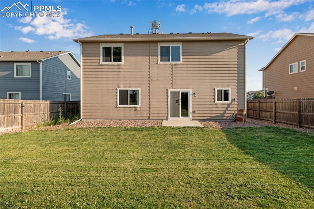 Image 42 of 43: Rear view of house featuring a fenced backyard