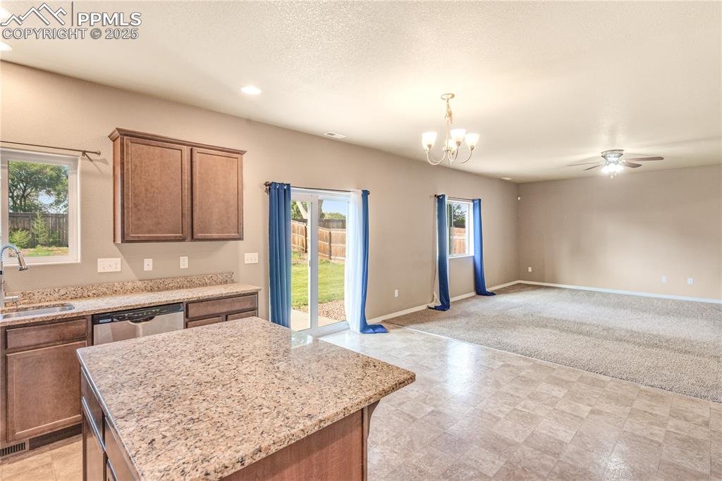 Image 6 of 43: Kitchen with open floor plan, a ceiling fan, stainless steel dishwasher, a