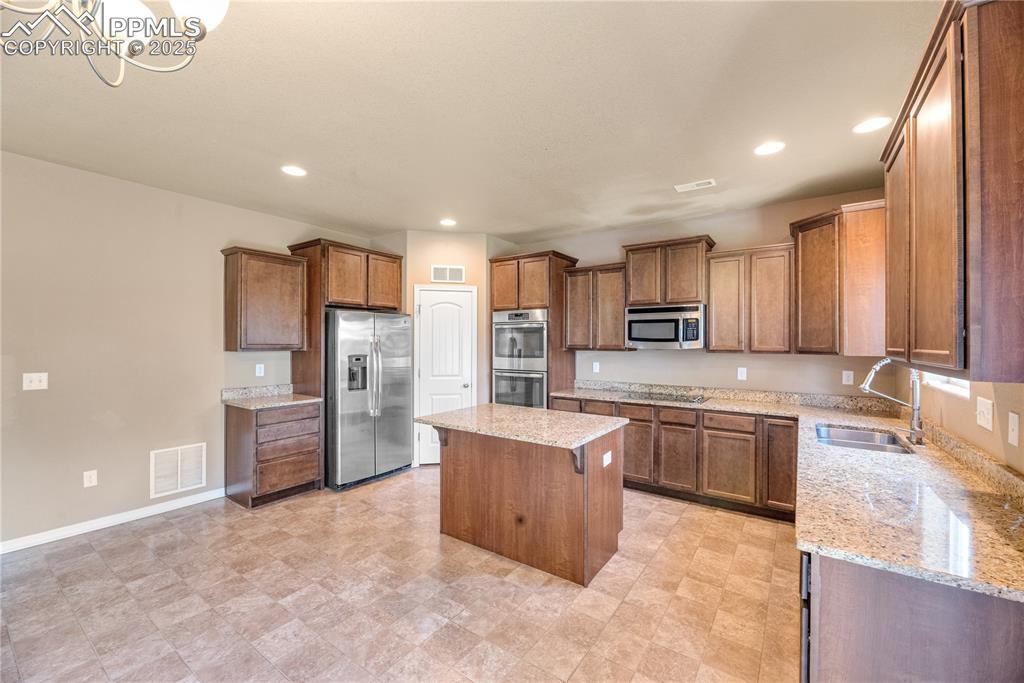 Image 9 of 43: Kitchen featuring stainless steel appliances, recessed lighting, a center i