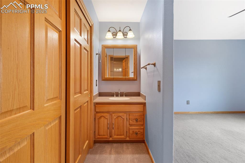 Image 25 of 50: Bathroom featuring vanity and baseboards
