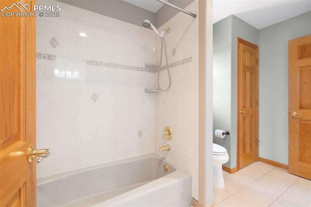 Image 26 of 50: Full bathroom featuring shower / bath combination and tile patterned floori