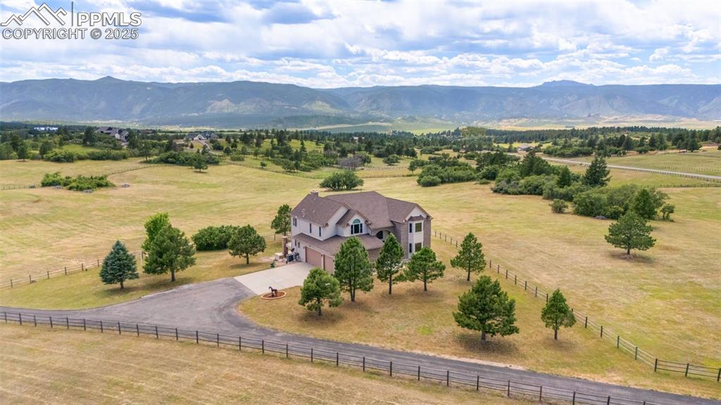 Image 4 of 50: View of rural area featuring a pastoral area and mountains
