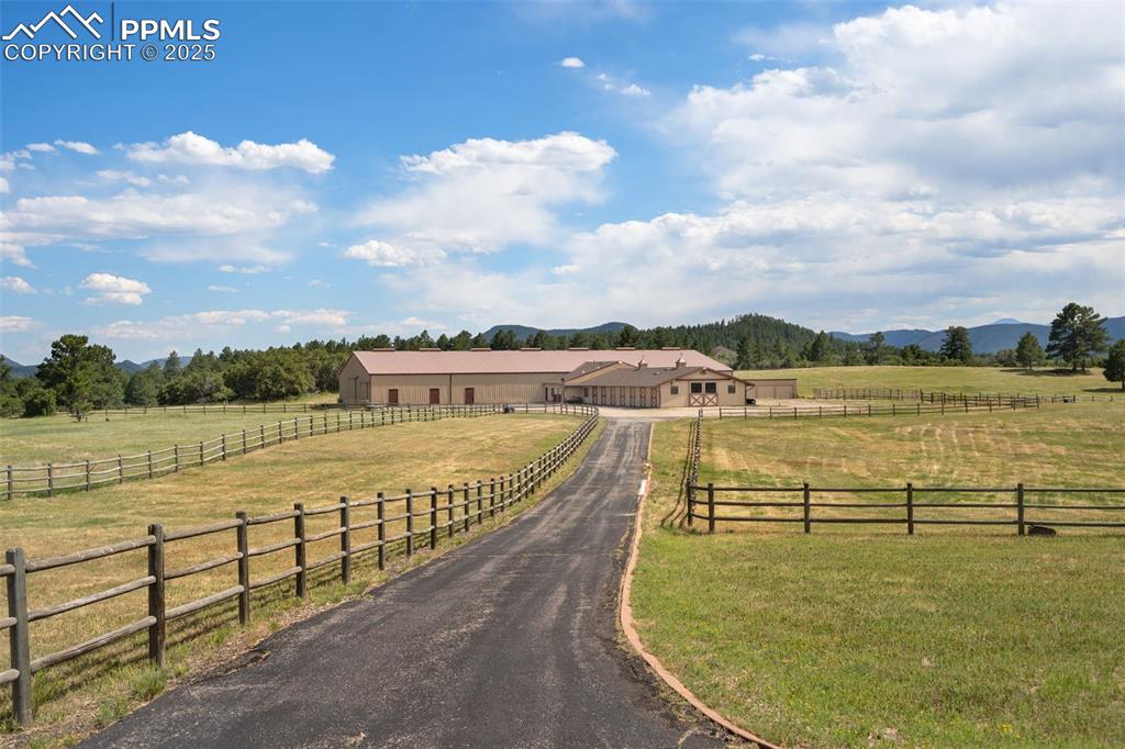 Image 41 of 50: View of asphalt driveway featuring a view of rural / pastoral area