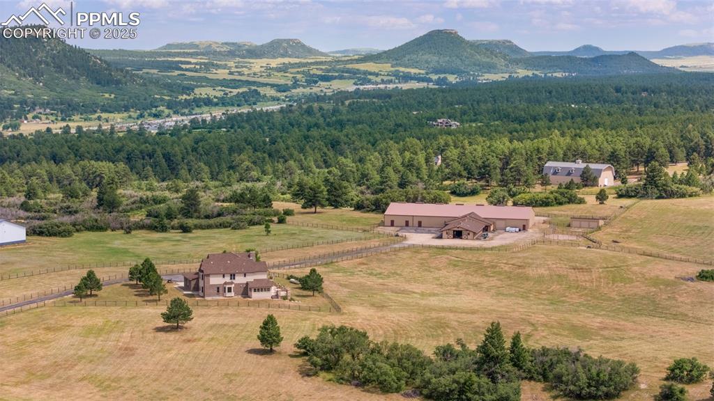Image 5 of 50: Overview of rural landscape featuring mountains and a heavily wooded area