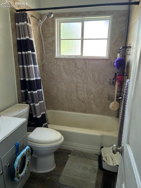 Image 10 of 18: Bathroom with vanity, wood finished floors, and shower / bath combo with sh