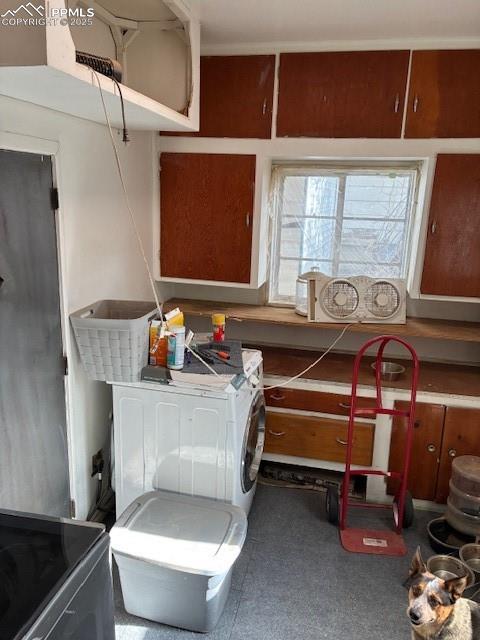 Image 17 of 18: Washroom with independent washer and dryer and cabinet space