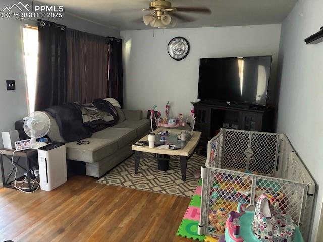 Image 2 of 18: Living room with wood finished floors and ceiling fan