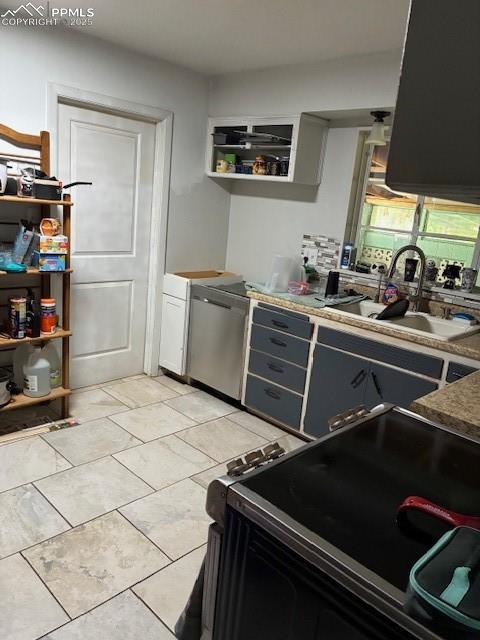 Image 7 of 18: Kitchen featuring stove, gray cabinetry, and dishwasher