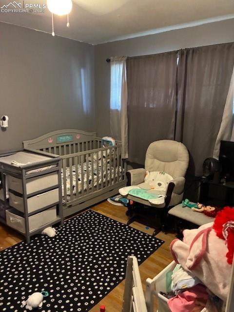 Image 9 of 18: Bedroom with wood finished floors
