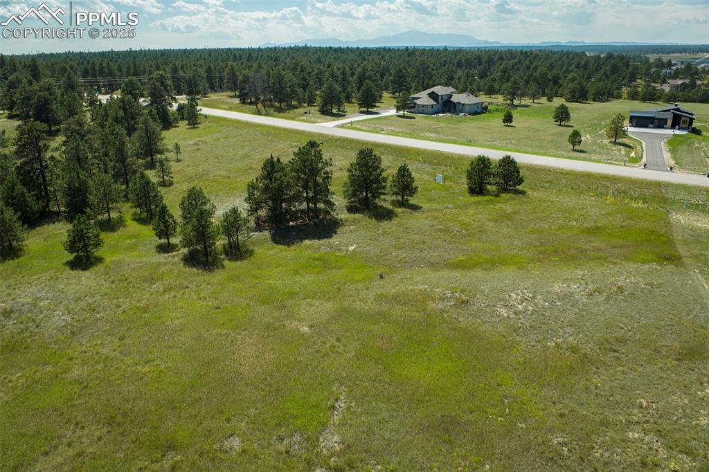 Image 19 of 19: Overview of rural landscape featuring a heavily wooded area