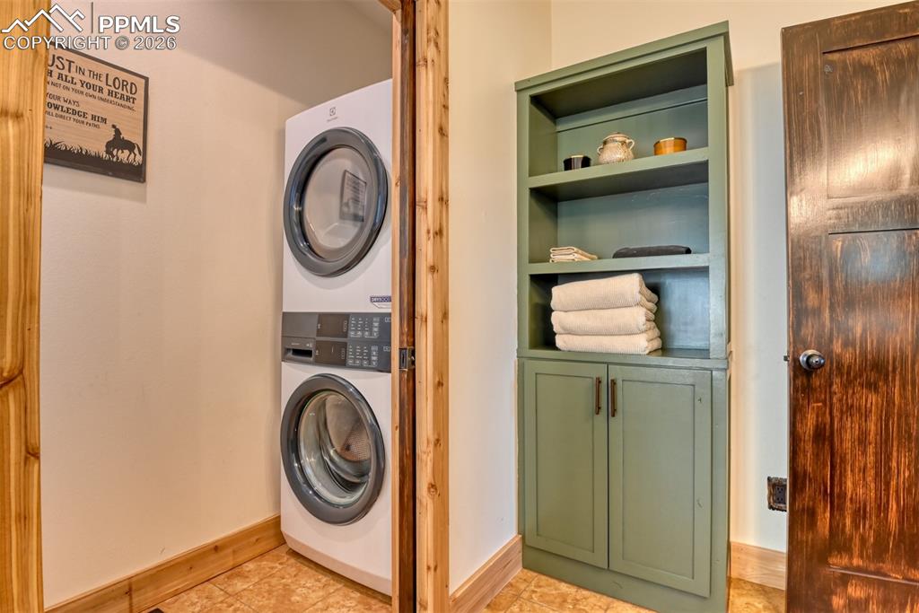 Image 22 of 50: Stackable washer and dryer located in the primary bathroom across from the 