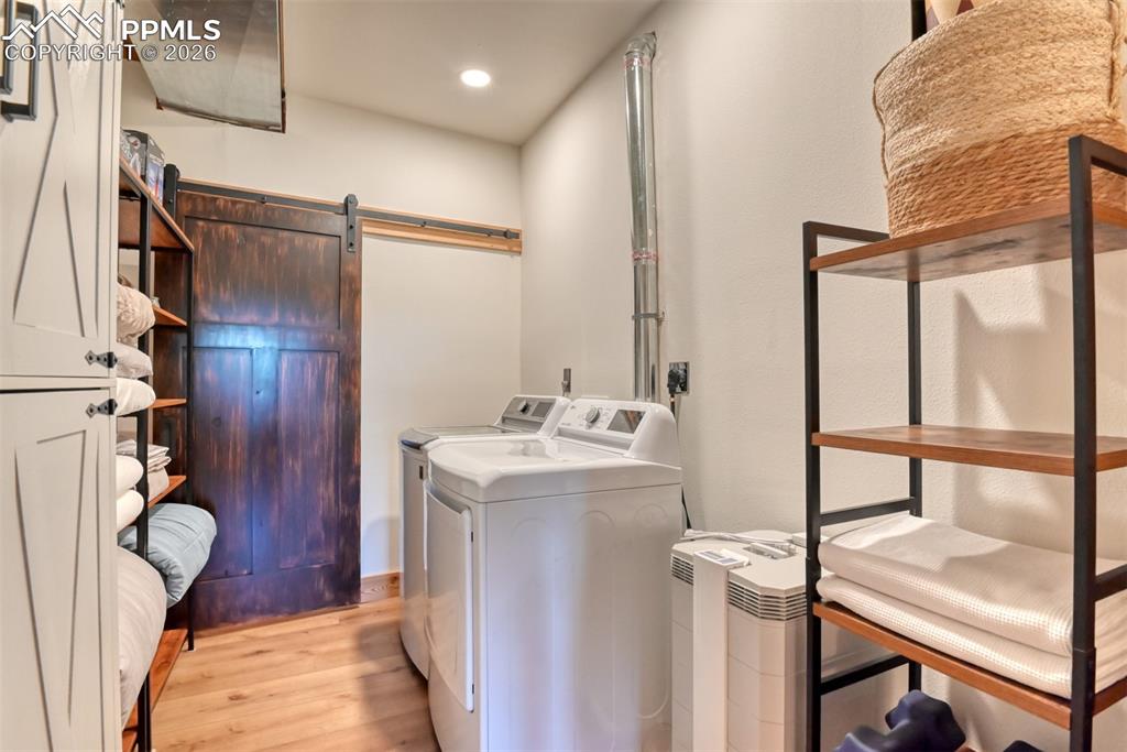 Image 34 of 50: 2nd washer and dryer in basement laundry room. Mechanical room behind barn 