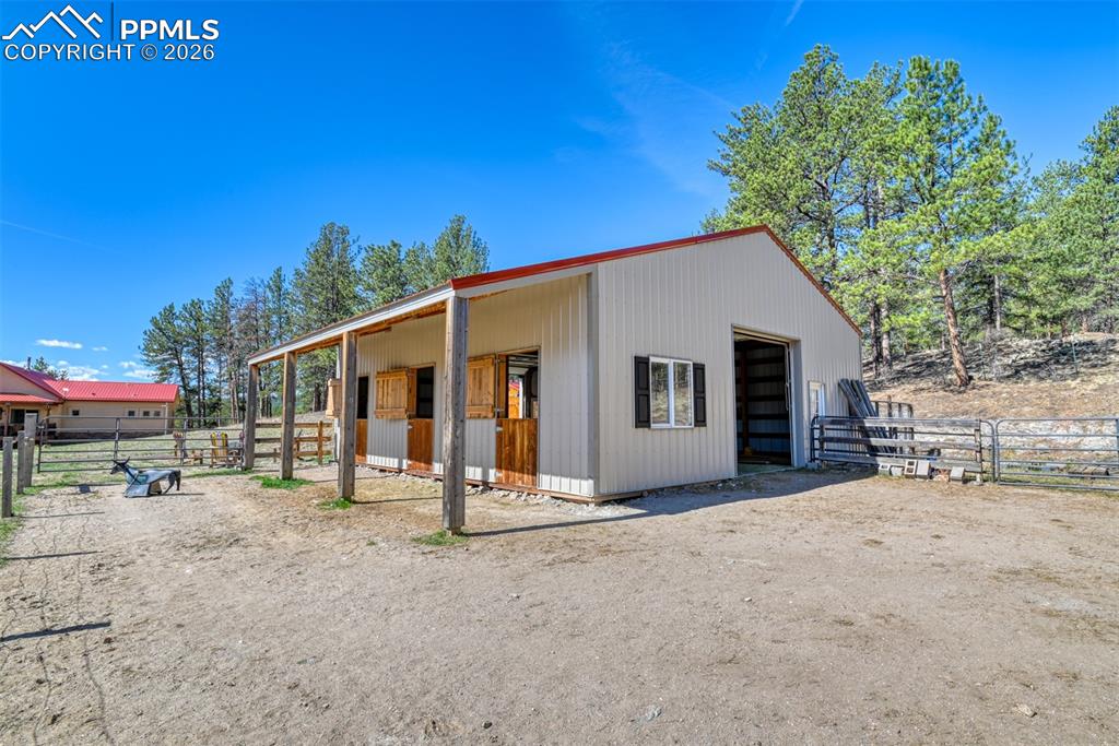 Image 42 of 50: Detached multi use pole barn is great workshop with water and electric and 