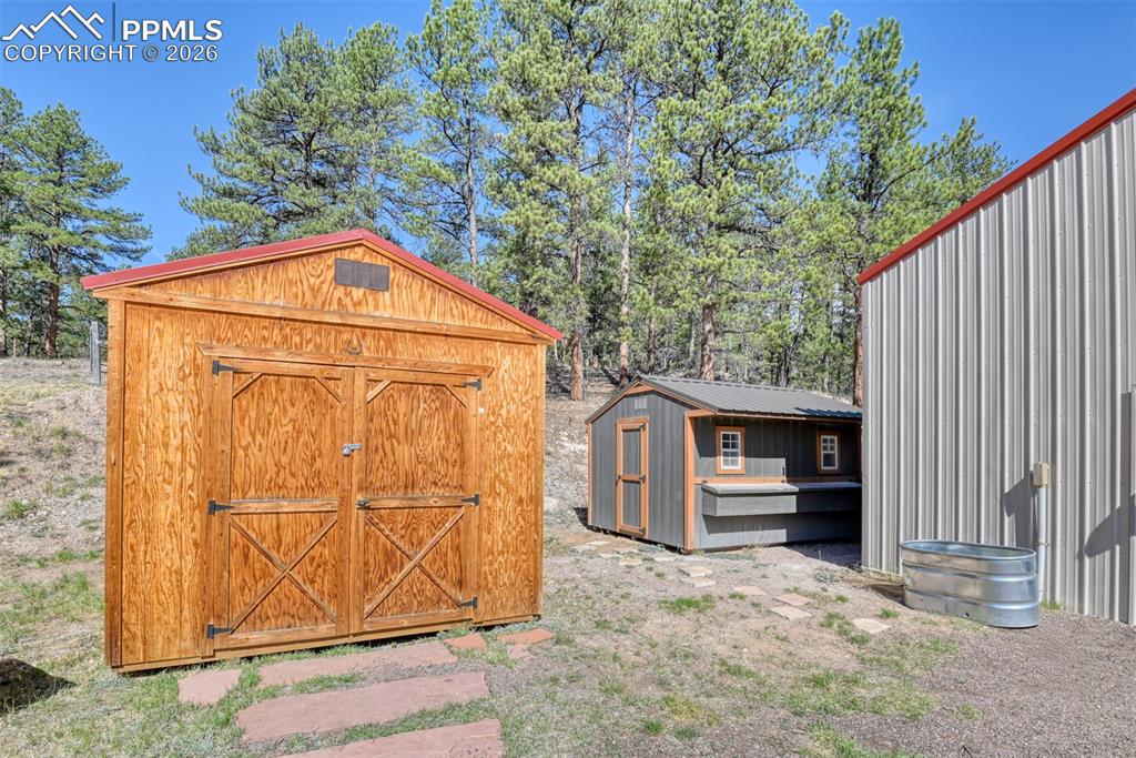 Image 43 of 50: Storage shed and new built chicken coup is ready for some chickens. 