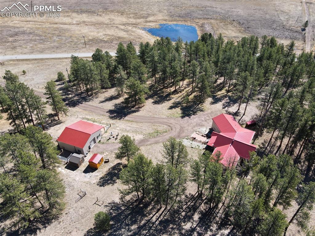 Image 47 of 50: Aerial view showing pond on nearby property