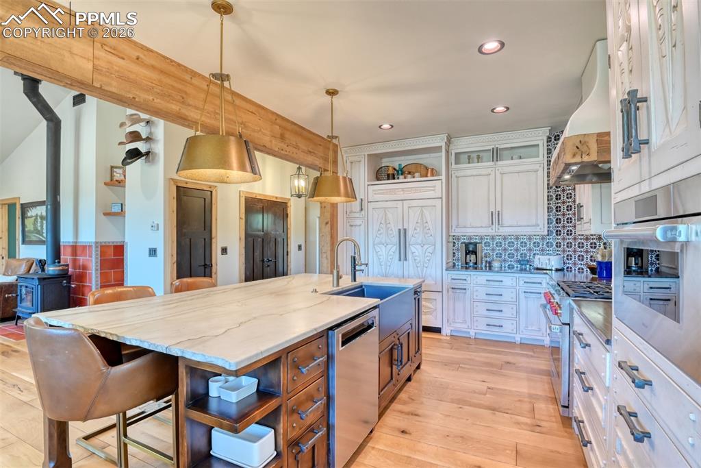 Image 7 of 50: Kitchenaid dishwasher, subzero refrigerator, Wolf gas cook top, built-in Br