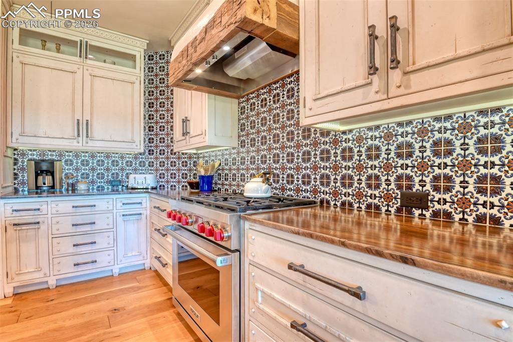 Image 8 of 50: Custom quartzite leathered countertops on the wall and quartzite honed on i