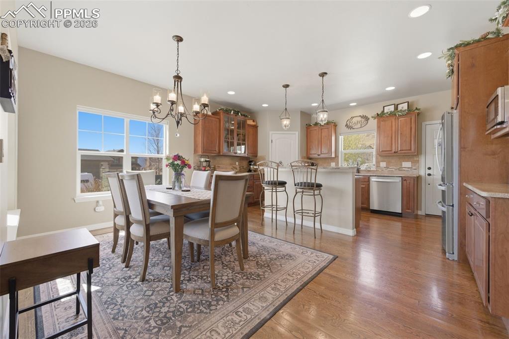 Image 11 of 50: Office area with dark wood finished floors and recessed lighting