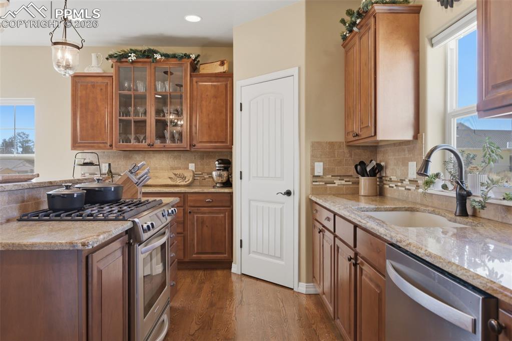 Image 16 of 50: Dining room with healthy amount of natural light, wood finished floors, and