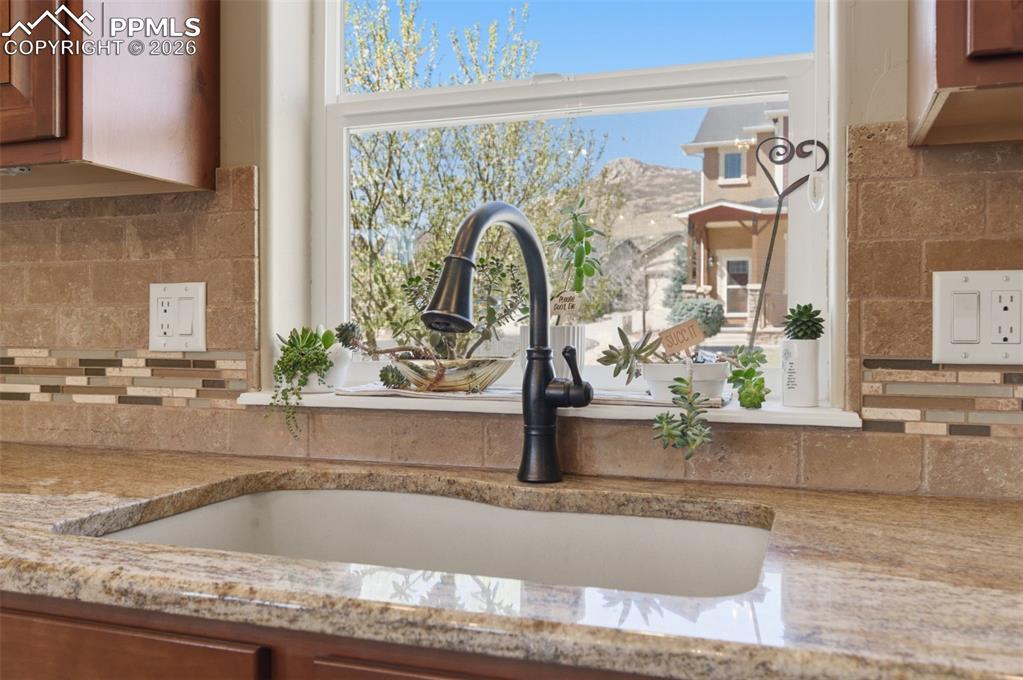 Image 17 of 50: Kitchen featuring wood finish cabinetry, glass insert cabinets, dishwasher,